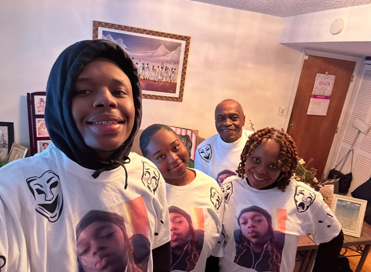 Four people in matching shirts smiling together at a Mahari In Motion gathering